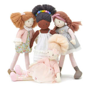 Group of diverse fabric rag dolls in pastel outfits and hairstyles