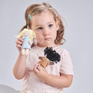 A toddler holding two soft dolls, perfect dolls for 1-year-olds, showcasing safe and engaging toys designed for early childhood development.